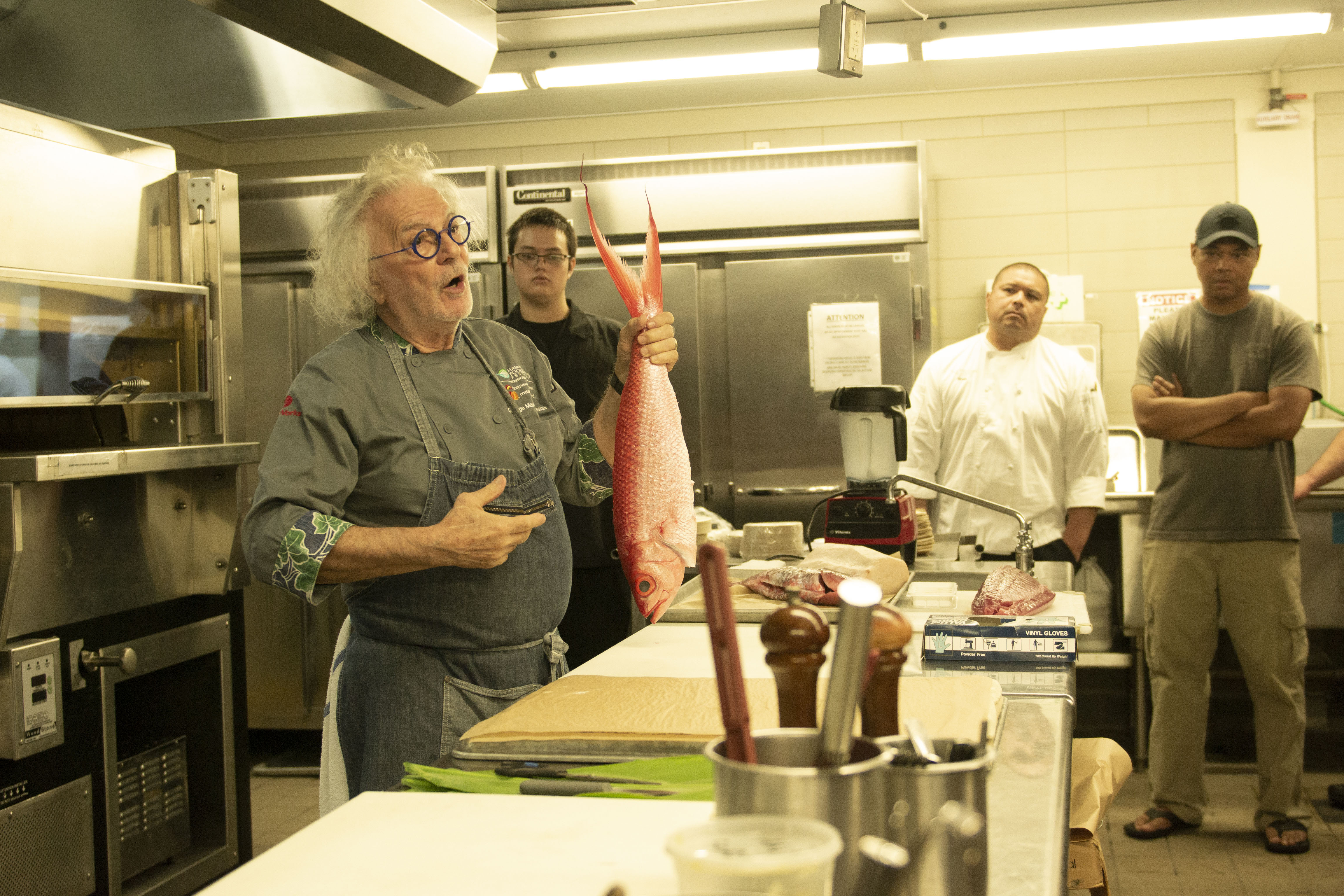Chef Mavro holds an onaga, or long-tail red snapper, as he leads the “Hook to Plate” workshop at the Hawaii Community College – Palamanui campus in Kona. 