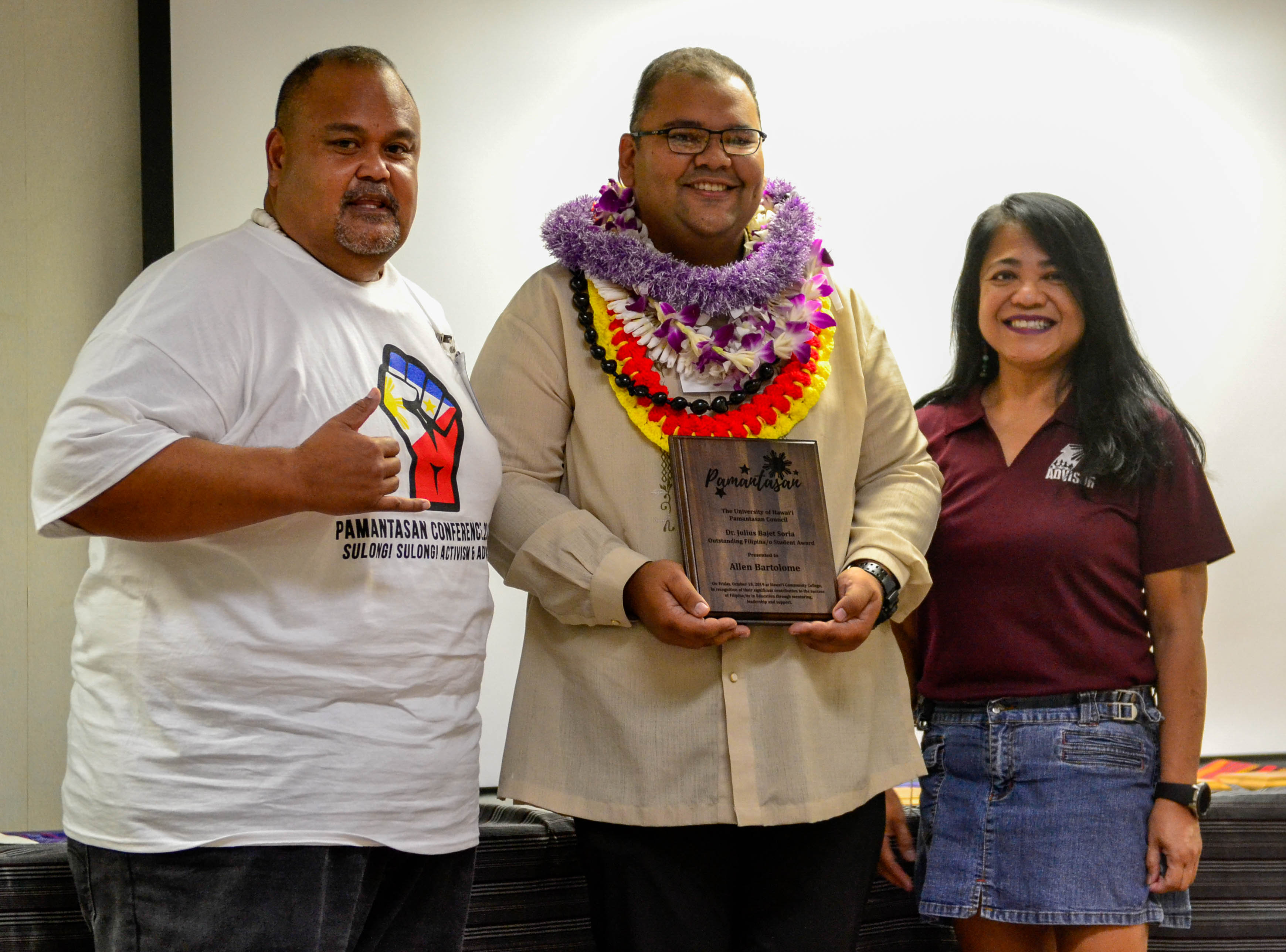 Allen Bartolome, center, receives the Dr. Julius Soria Award. 
