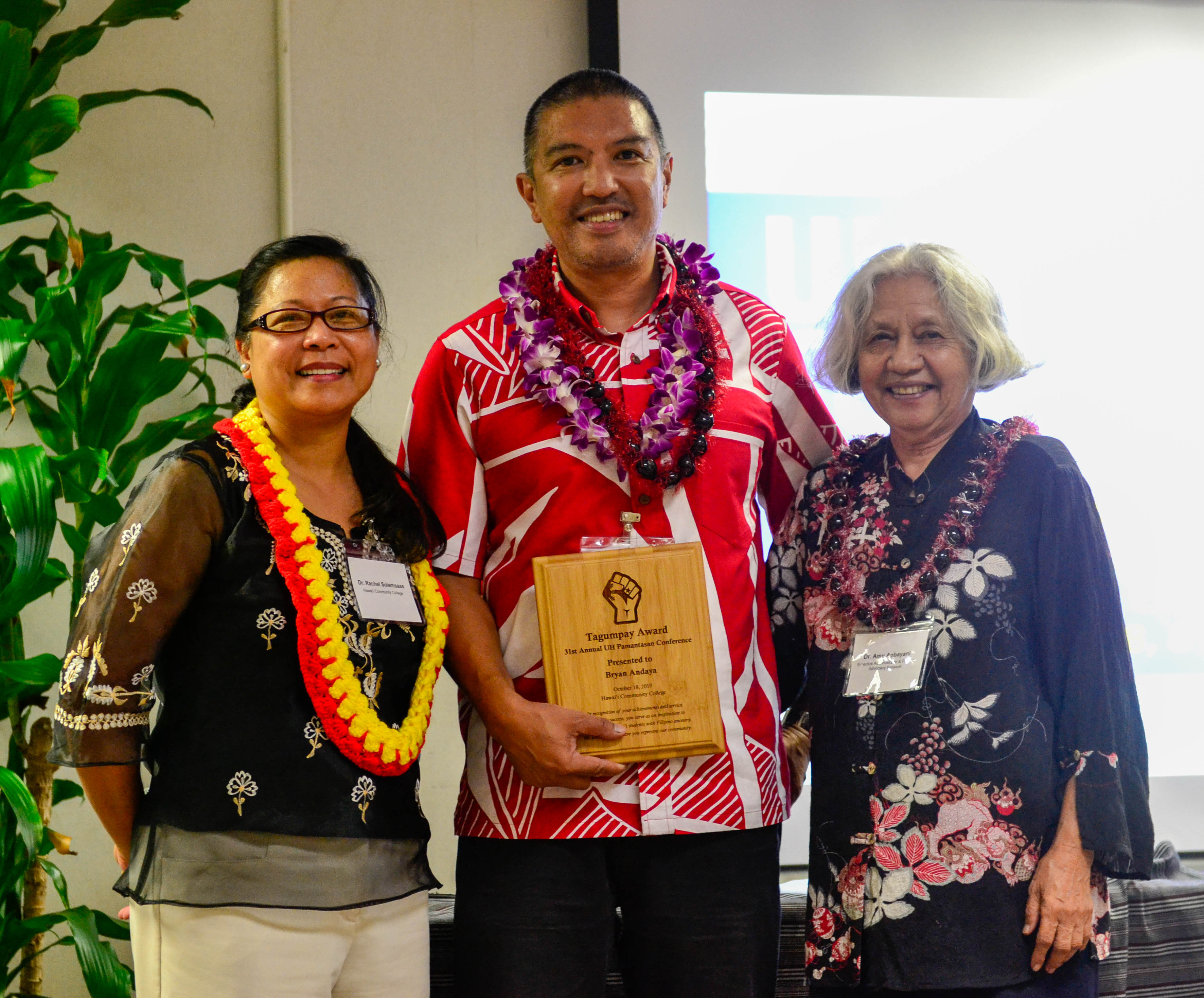 Bryan Andaya, center, receives the Tagumpay Award. 