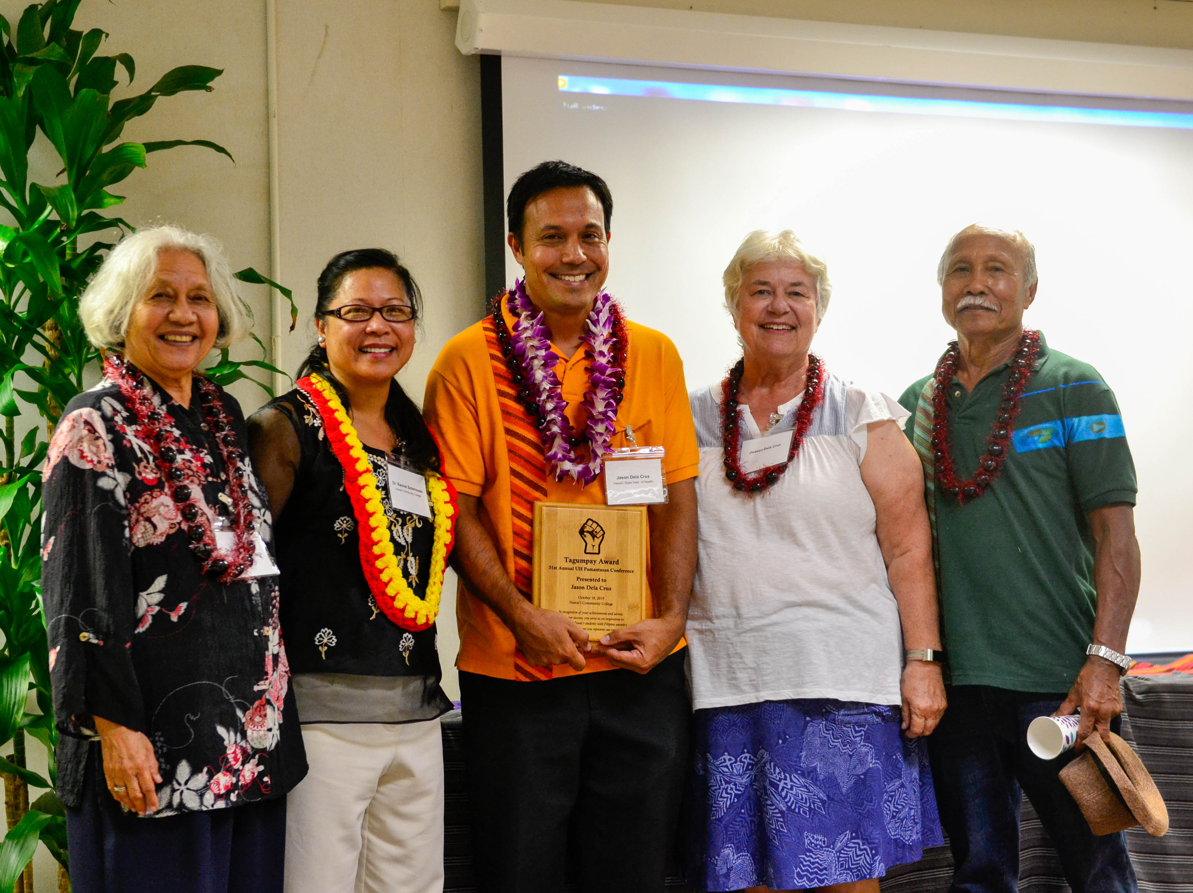 Jason Dela Cruz, center, receives the Tagumpay Award. 