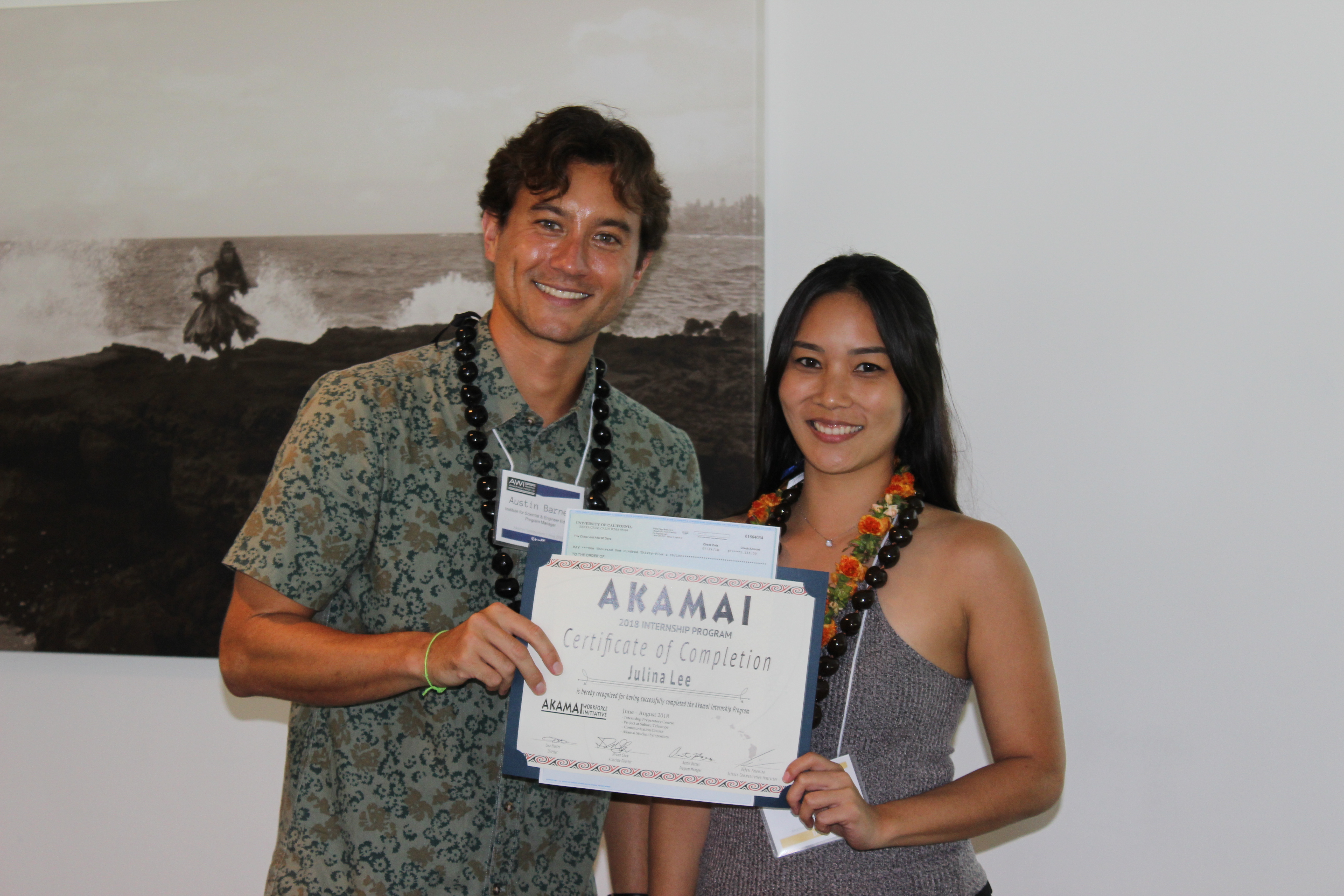 Two students post with certificate