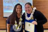 Kenoalani Dela Cruz accepts the Regional Coordinator’s Advisor Award from Erin Millard.